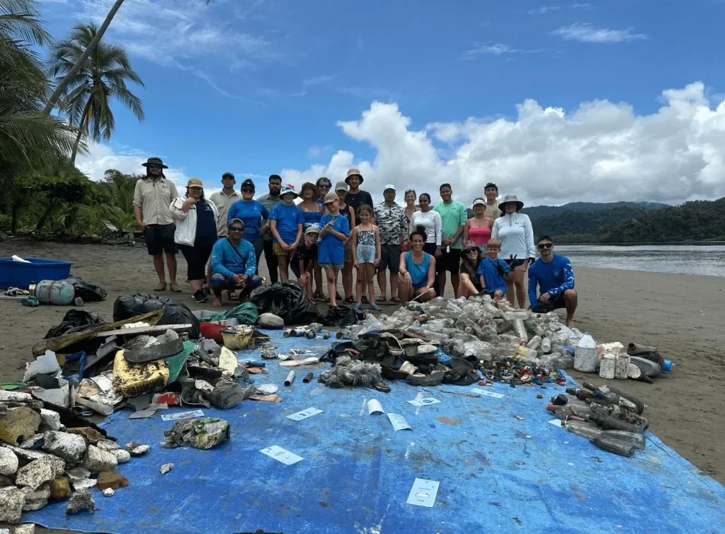 Environmental volunteers displaying collected beach trash and marine debris Costa Rica