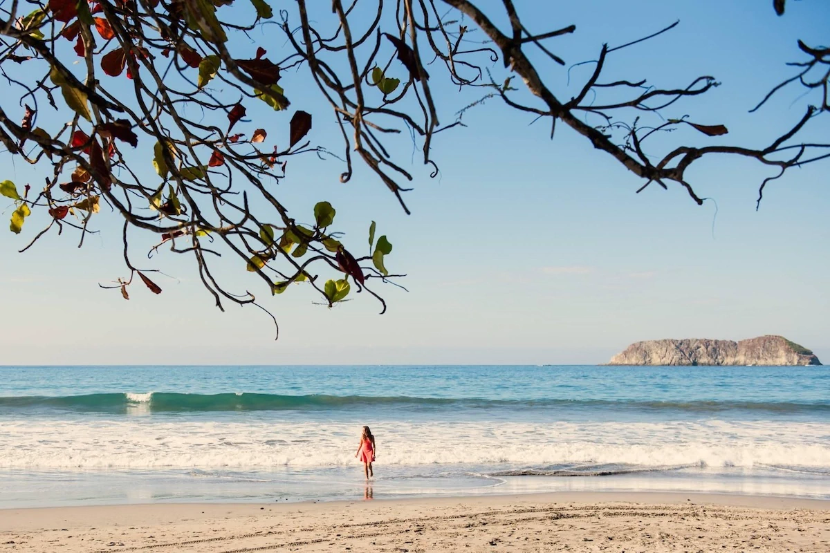 Beach in Uvita Costa Rica with ocean waves and island view near Marino Ballena