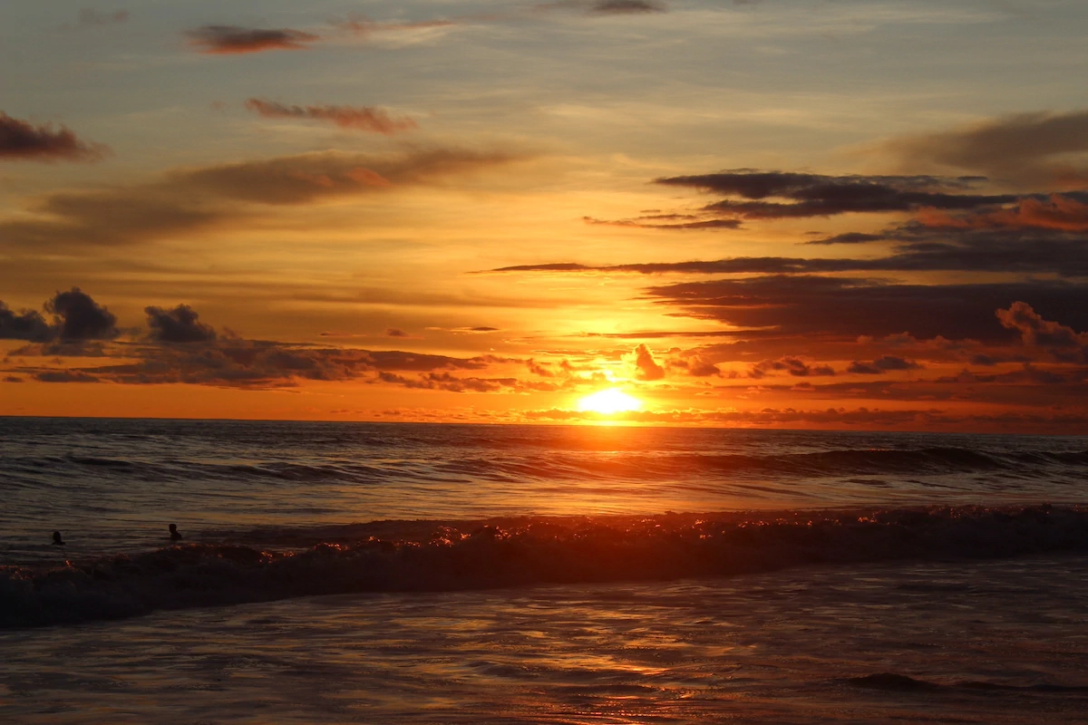 Ocean sunset in Costa Rica with waves and golden sky over the Pacific